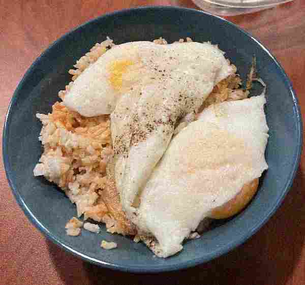 A yummy-looking bowl of
      rice with eggs. The image is very compressed.